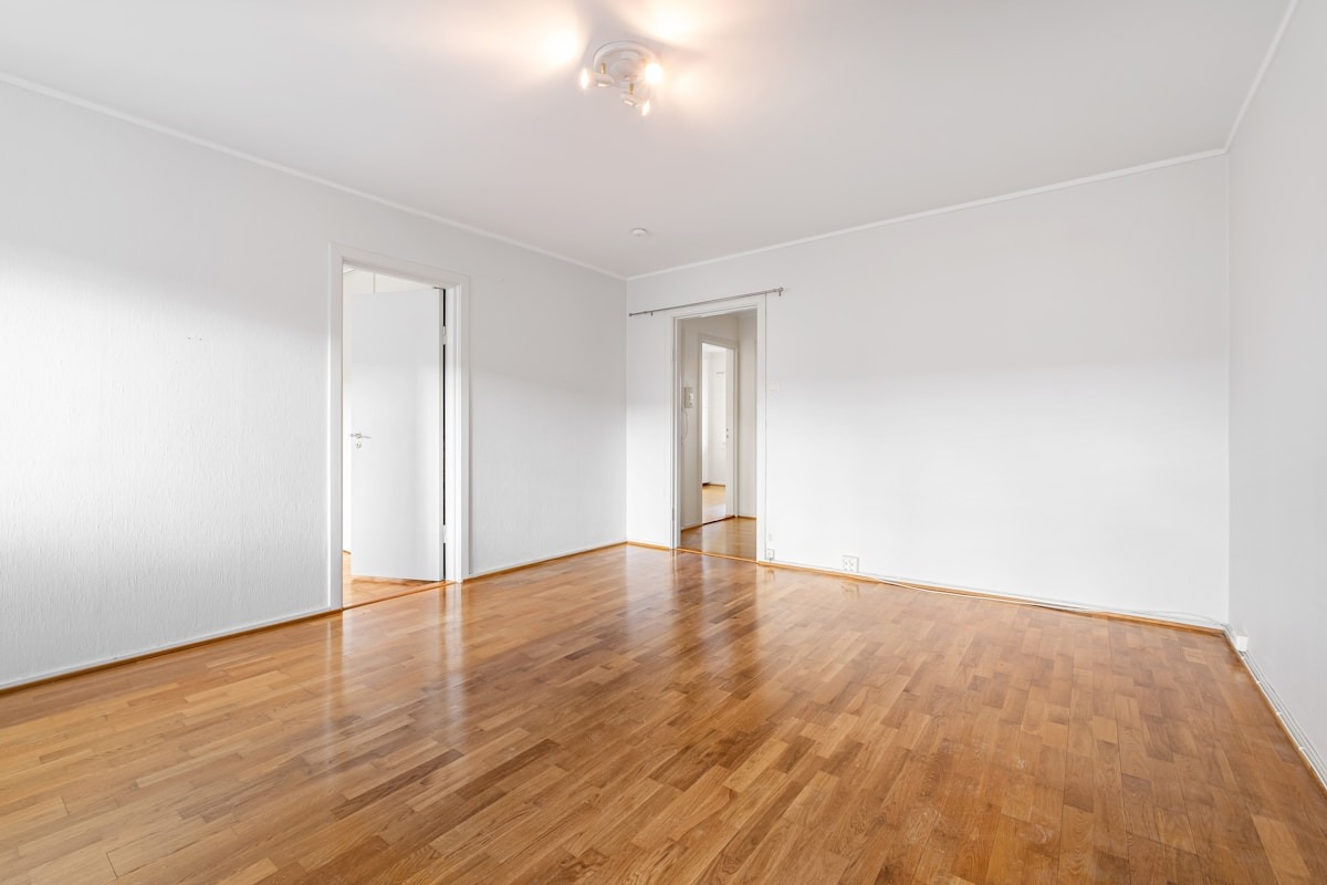Original empty living room with two doors